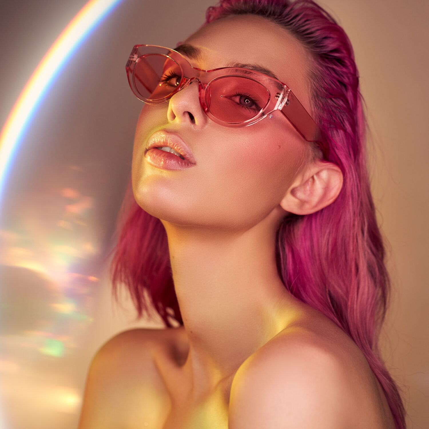 Sexy Woman with creative hair coloring in pink red, girl in sunglasses. Beautiful smile